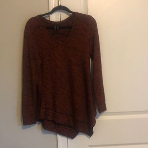 Medium New Directions women’s vneck sweater. Rust and black in color.